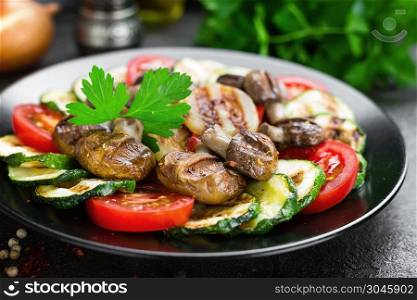 Salad with fresh and grilled vegetables and mushrooms. Vegetable salad with grilled ch&ignons. Vegetable salad on plate