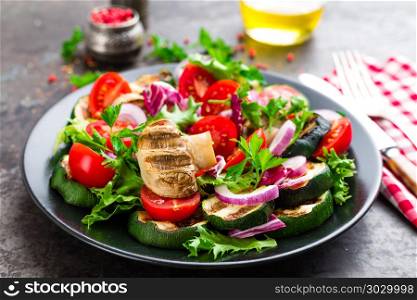 Salad with fresh and grilled vegetables and mushrooms. Vegetable salad with grilled champignons. Vegetable salad on plate. Healthy vegetarian food