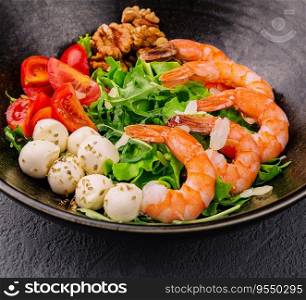 Salad with fresh arugula leaves, mozzarella cheese and shrimps