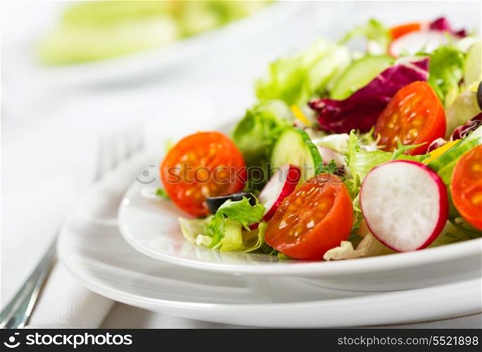 salad with fresh vegetables anf greens on plate