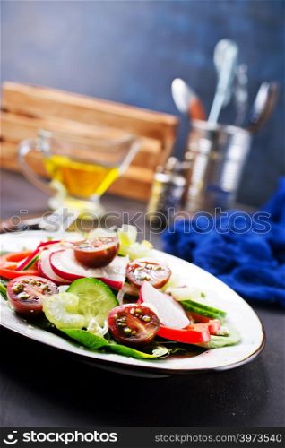 salad with fresh vegetables on plate on a table