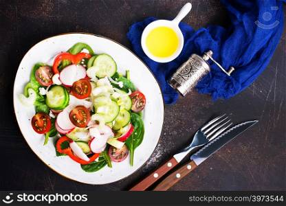 salad with fresh vegetables on plate on a table