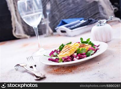 salad with fried cheese on white plate