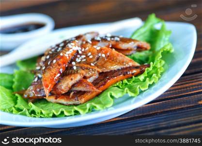salad with fried eel and sauce on the plate