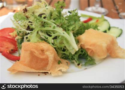 salad with fried goat cheese and tomato, french cuisine