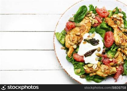 Salad with grilled chicken fillet, spinach and citrus fruits. Invalid food, healthy food. Space for text. Spicy salad with chicken breast, herbs and fruits