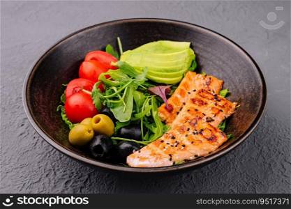 salad with grilled salmon, avocado, tomatoes with arugula