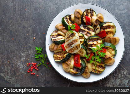 Salad with grilled vegetables and mushrooms. Vegetable salad with grilled champignons. Grilled salad on plate