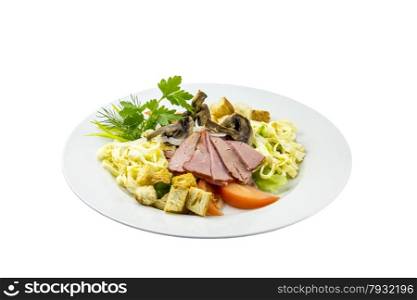 Salad with ham, mushrooms, tomatoes and pasta on an isolated background