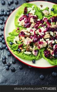 Salad with herbs, grilled chicken, nuts and blueberries.Healthy food. Chicken breast salad, greens, blueberries