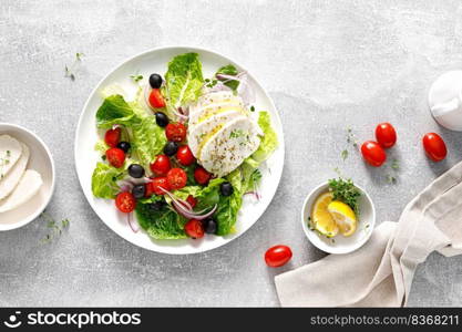 Salad with mozzarella cheese, cherry tomato, olives and romain lettuce, top view