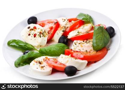 salad with mozzarella, tomatoes and basil on white background