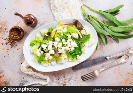 salad with oil and cheese in the bowl