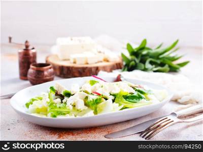 salad with oil and cheese in the bowl