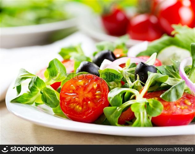 salad with olives, vegetables and greens