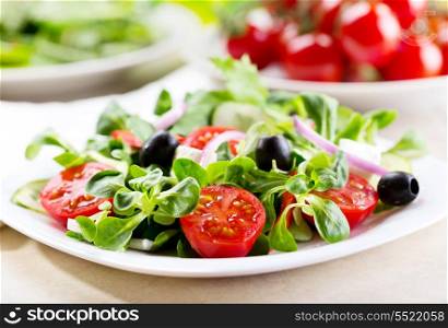 salad with olives, vegetables and greens