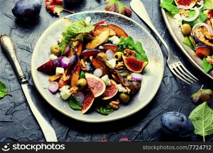 Salad with plums,figs,olives and feta cheese.Autumn salad of fruits and herbs.. Autumn fruit salad