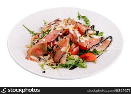 Salad with prosciutto, tomato, arugula leaves on plate