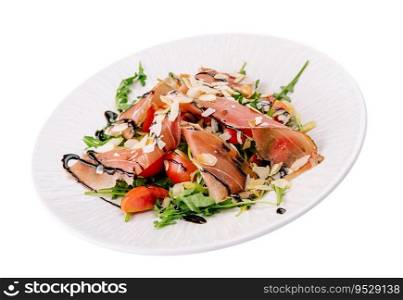 Salad with prosciutto, tomato, arugula leaves on plate