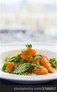 salad with pumpkin, seeds and pea on bakground of light window in city
