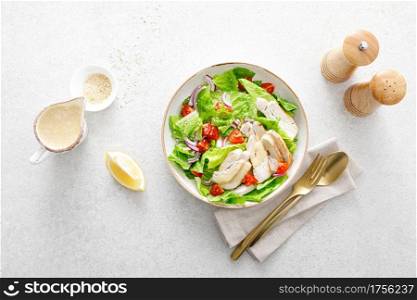 Salad with romaine lettuce, grilled chicken meat and tomatoes