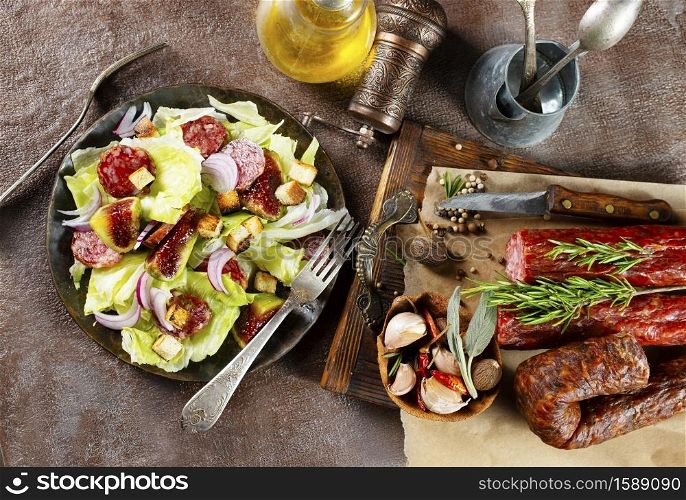 salad with salami and fresh fig on plate