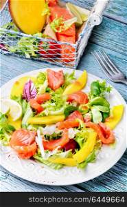 Salad with salmon,mango and fresh herbs. lettuce salad with fish