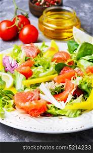Salad with salmon,mango and fresh lettuce. Fish salad with salmon and vegetables