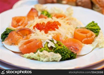 Salad with salmon. Salad with salmon with red caviar and cheese