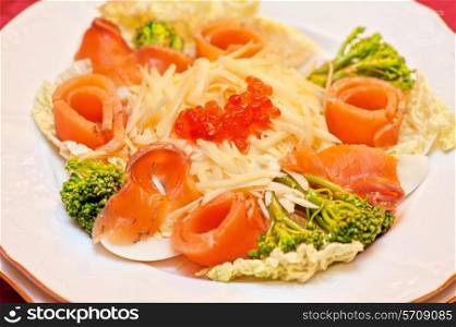 Salad with salmon with red caviar and cheese