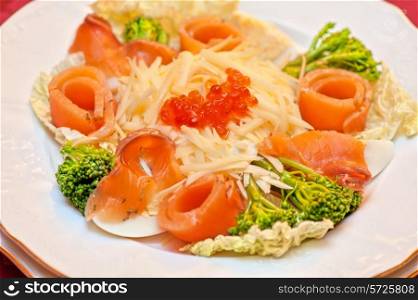 Salad with salmon with red caviar and cheese