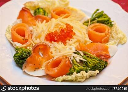 Salad with salmon with red caviar and cheese. Salad with salmon