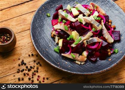 Salad with salted herring,beets,onions and green peas.. Classic herring salad