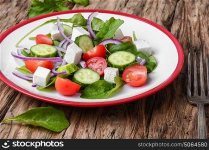 salad with spinach, cheese and tomato. fresh vegetable salad with cucumber,cheese and tomato