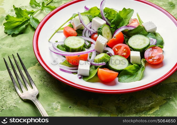 salad with spinach, cheese and tomato. spring vegetable salad with cucumber,cheese and tomato