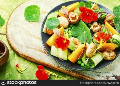 Salad with stewed mushrooms, cucumber,tomato and nasturtium.. Mushroom salad with vegetables
