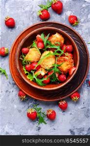 Salad with strawberry and fried cheese. Salad with strawberries, fried cheese and rucola.Healthy eating,