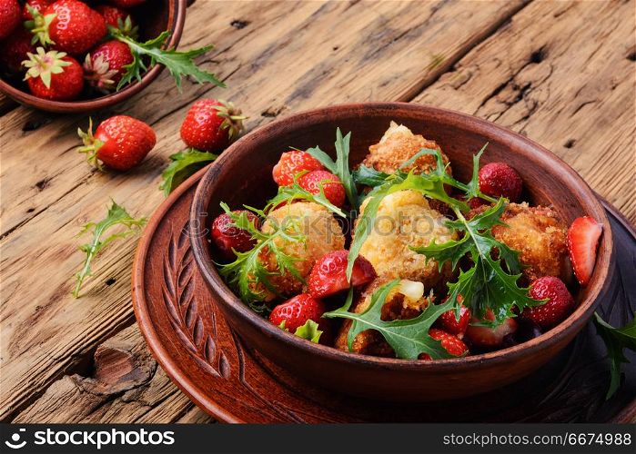 Salad with strawberry and fried cheese. Summer salad with strawberries, fried cheese and lettuce