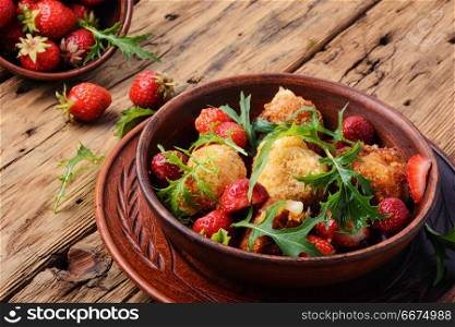 Salad with strawberry and fried cheese. Summer salad with strawberries, fried cheese and lettuce