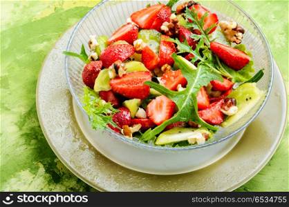 salad with strawberry. dietary summer salad with strawberries, fruits and lettuce