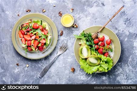 salad with strawberry. dietary summer salad with strawberries, fruits and lettuce