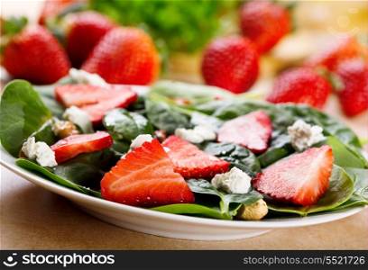 salad with strawberry, spinach leaves and feta cheese