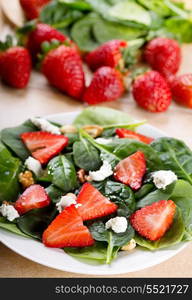 salad with strawberry, spinach leaves and feta cheese