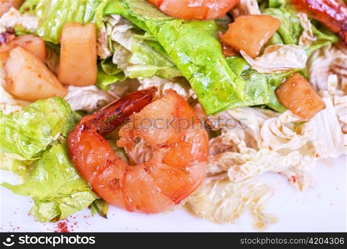 Salad with tiger shrimps and vegetable closeup