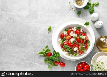 Salad with tomato, italian ricotta cheese and basil, top view