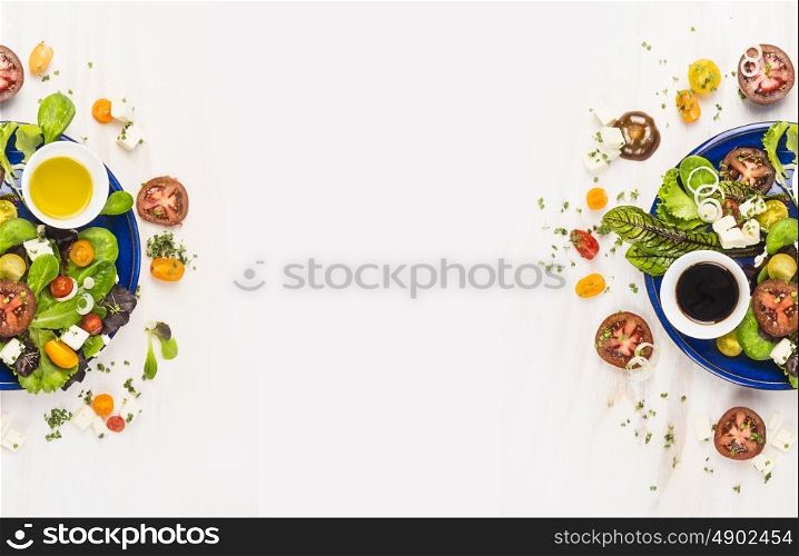 salad with tomatoes, greens, dressing, oil and feta cheese in blue plate on white wooden background, top view , banner for website with cooking concept