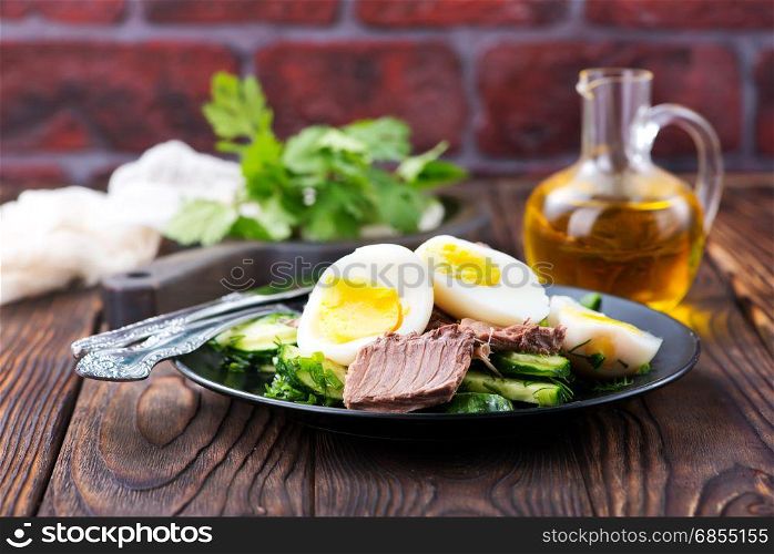 salad with tuna on the black plate