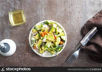 salad with vegetables and avocado on plate