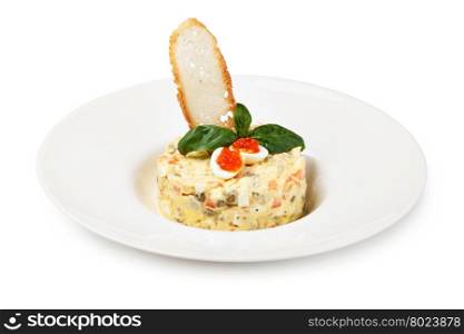 Salade Olivier decorated with red caviar, mayonnaise