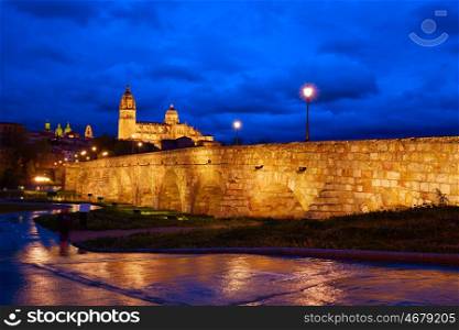 Salamanca skyline sunset and roman bridge over Tormes river in Spain
